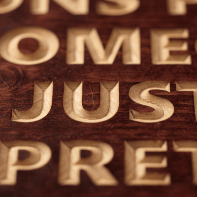 Macro close-up of the CNC carved letters spelling SOMEONE JUST PRETEND on the integrity wood sign revealing real pine grain, hand-finished depth, and authentic Kentucky craftsmanship.