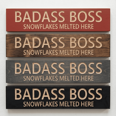 Four Badass Boss Snowflakes Melted Here signs in barn red, walnut, gray, and ebony finishes.