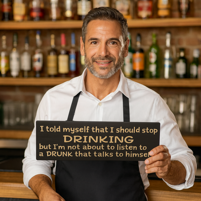Bartender holding the carved bartender gift sign with “I should stop drinking…” quote; product shown for scale.