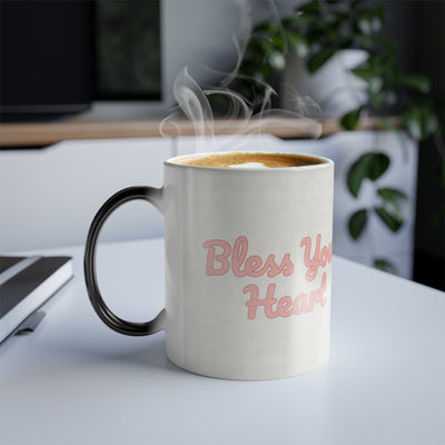 Steaming Bless Your Heart color changing magic mug on modern white desk, funny southern coffee cup from Bluegrass Gifts.
