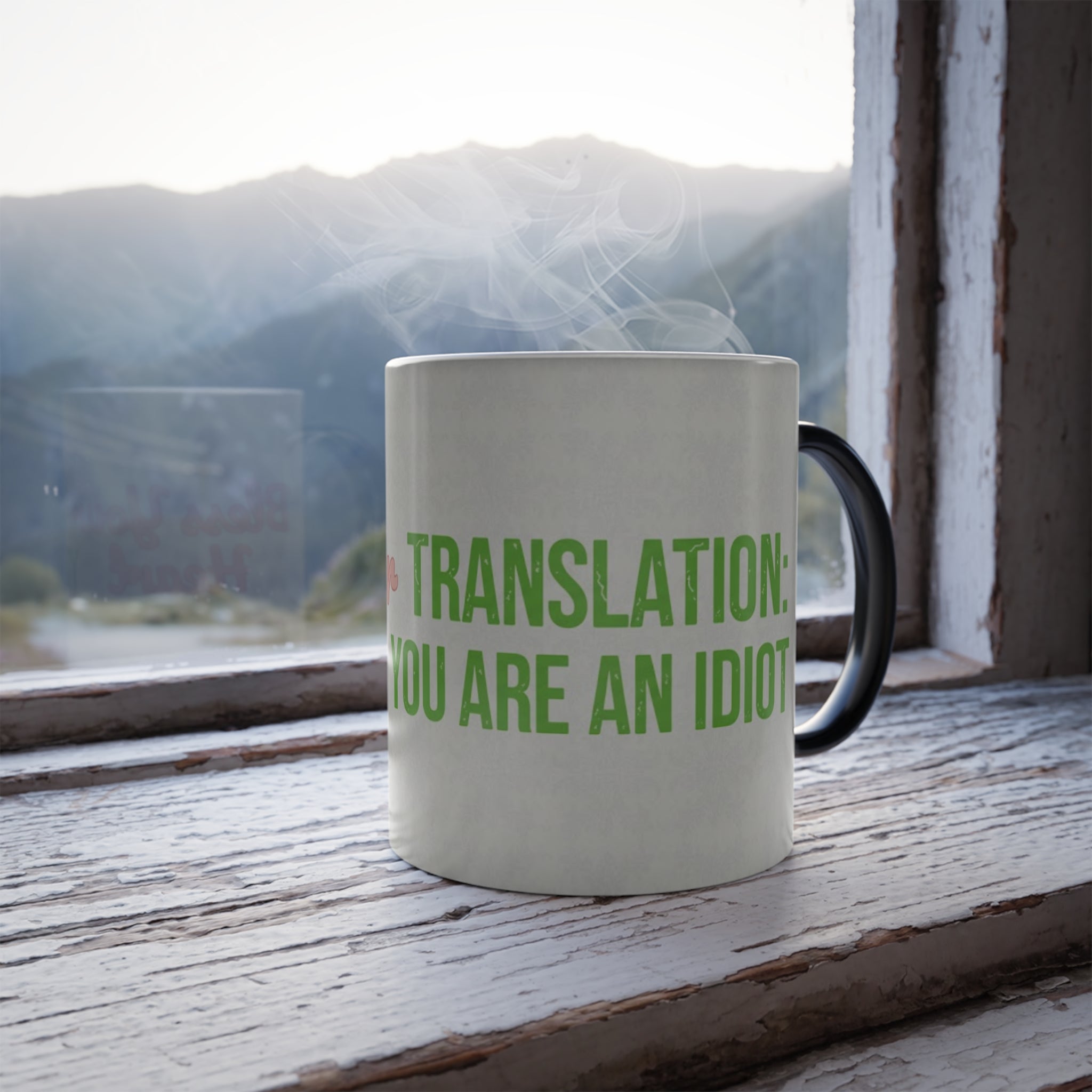 Steaming Bless Your Heart color changing mug on wooden window sill with full green translation you are an idiot text visible.