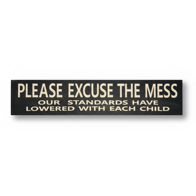 Hand-carved solid wood sign by Bluegrass Gifts featuring the quote "Please Excuse the Mess Our Standards Have Lowered With Each Child" in cream letters on black stain.