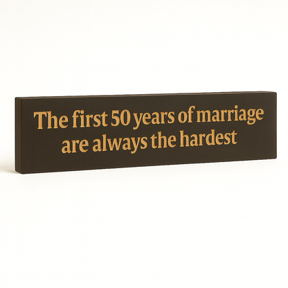 Angled studio shot of handcrafted wooden 50 years of marriage wall sign.