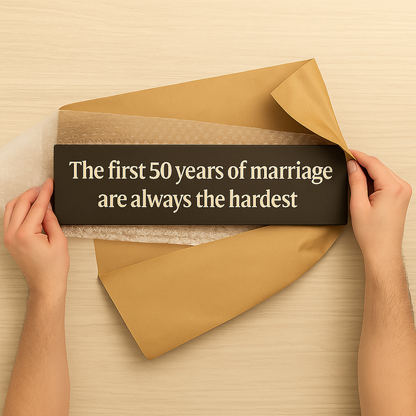 Wooden 50th anniversary marriage sign being unwrapped as a thoughtful gift.