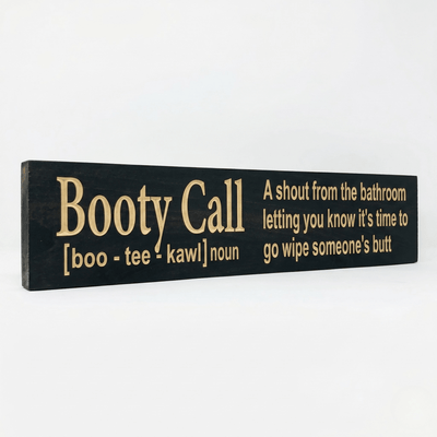 Angled view of the Booty Call funny parenting bathroom sign showing dimensional CNC-carved letters and rich Ebony stain on solid Pine