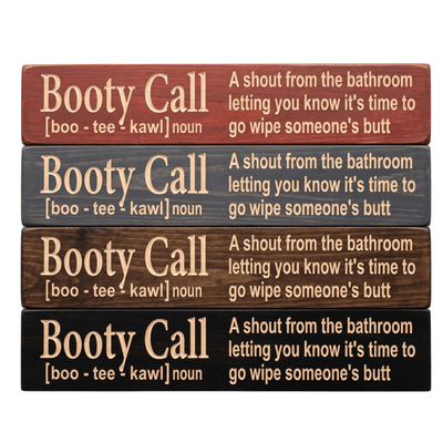 Four Booty Call CNC-carved bathroom signs stacked to show stain color options including Cabernet, Carbon Gray, Dark Walnut, and Ebony