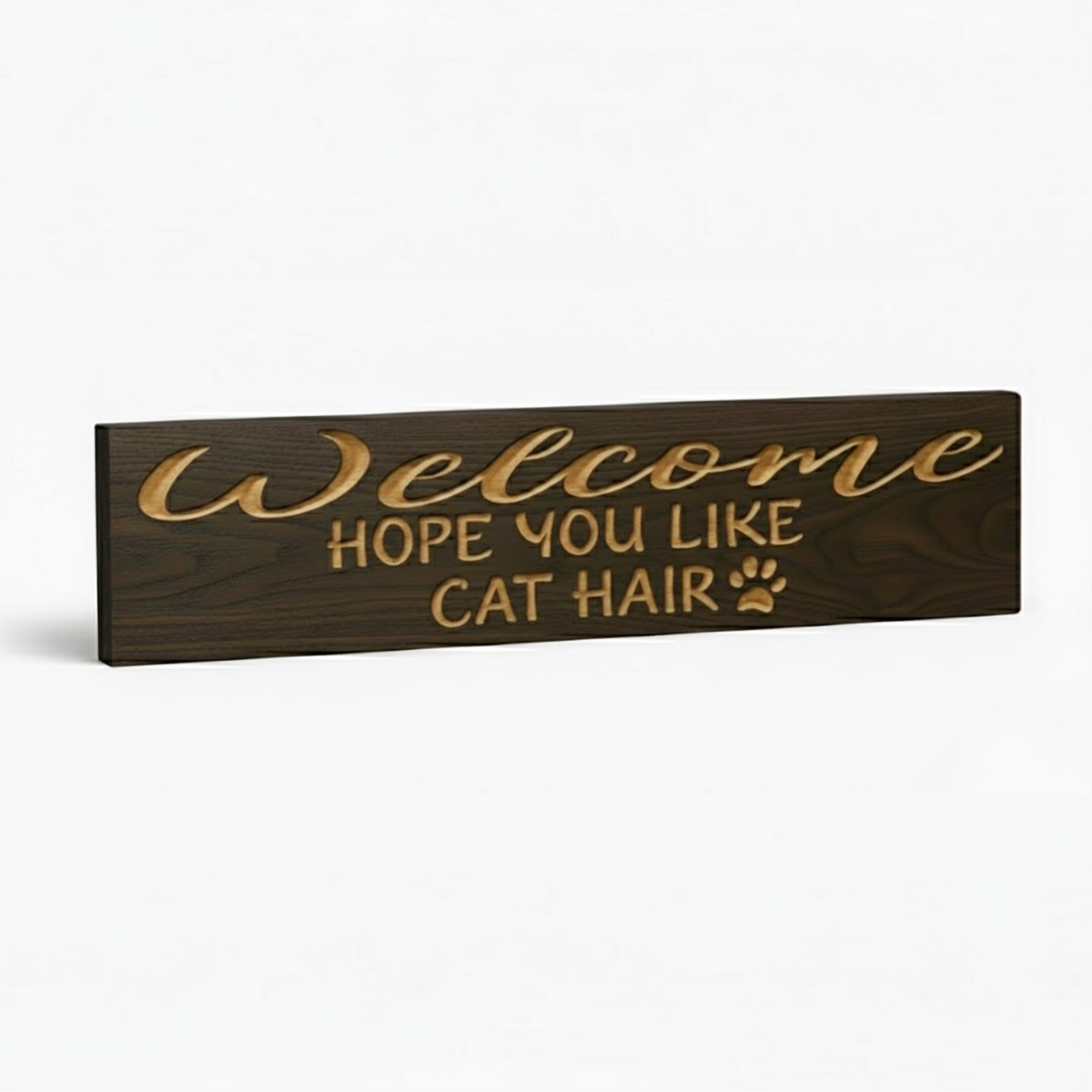 An angled view of the funny cat welcome sign, highlighting the 3D depth of the carved letters against the dark wood grain.