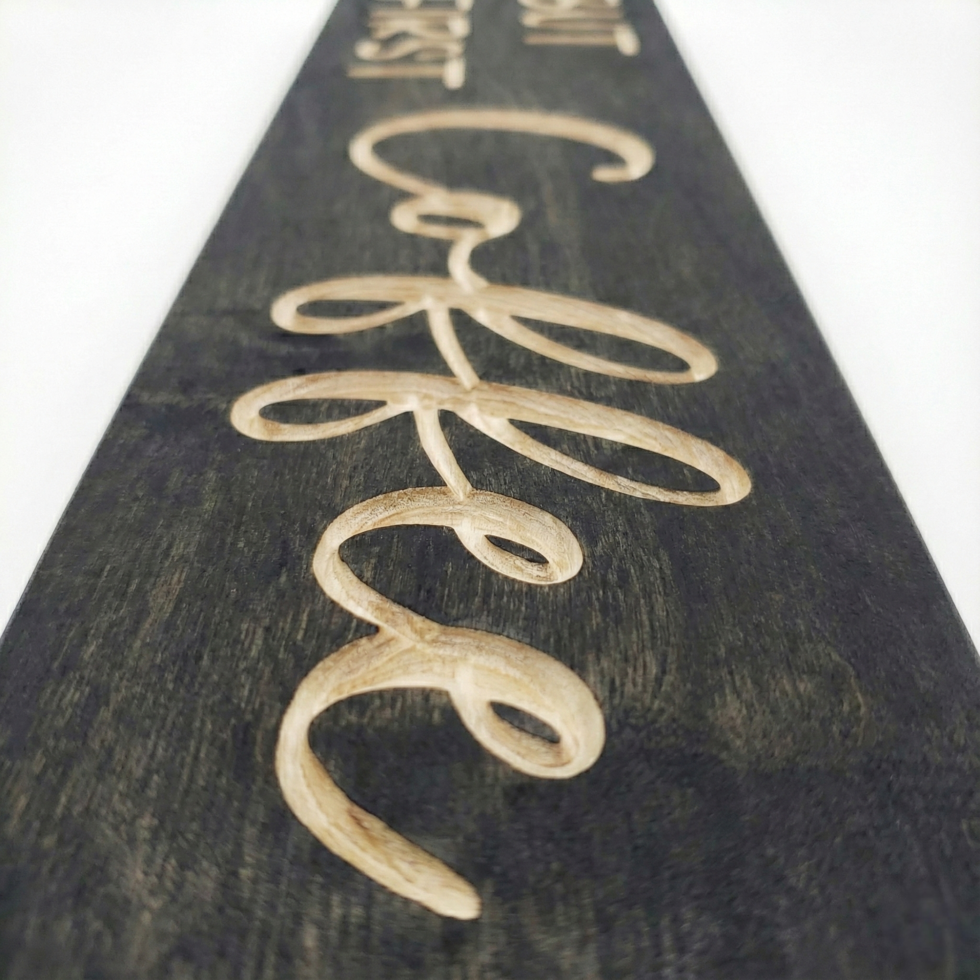 Macro detail shot showing the depth and natural wood grain of the V-carved letters on a Bluegrass Gifts coffee sign.