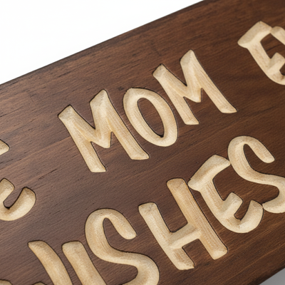 Macro shot showing the deep relief and natural wood grain of the CNC-carved letters on the sign.