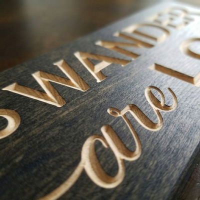 Macro detail shot of precision CNC v-carving on solid timber, highlighting the "Never Printed" quality of Bluegrass Gifts.