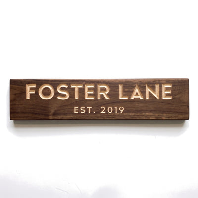 Personalized Foster Lane sign carved into solid wood in a Dark Walnut finish, straight on, on a white background (studio photo)