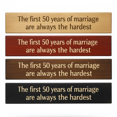 "Comparison of four handcrafted wood finishes: Natural, Barn Red, Dark Walnut, and Ebony for the 50th anniversary carved sign."