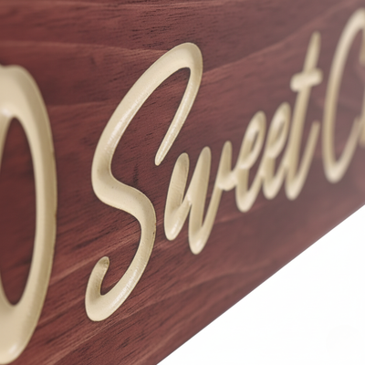Close-up detail of the deep 3D CNC carving on a Bluegrass Gifts solid wood sign, showing high-contrast natural wood grain.