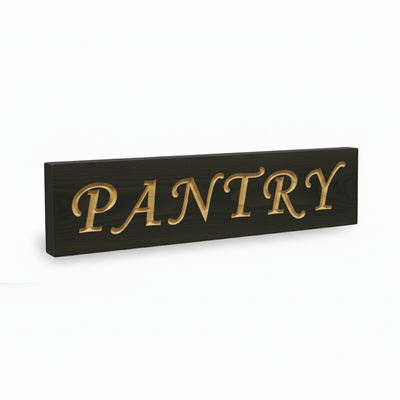 An angled view of a solid wood pantry door sign, showing the deep 3D v-carving of the elegant letters.