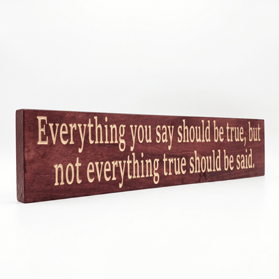 Angled view of the Everything You Say Should Be True wooden quote sign showing dimensional CNC-carved letters and rich Cabernet stain on solid Pine