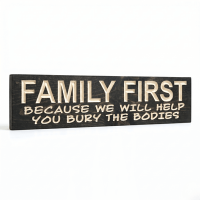 Angled view of the Family First funny farmhouse sign showcasing the dimensional depth of CNC-carved lettering against a dark ebony-stained solid wood background