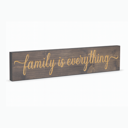 Family Is Everything wooden wall sign angled hero view showing carved lettering and natural wood finish