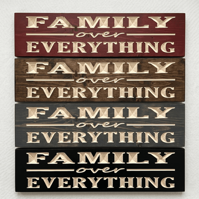 Four Family Over Everything CNC-carved wood signs stacked to show stain options including Cabernet, Dark Walnut, Weathered Gray, and Ebony
