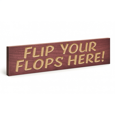 Flip Your Flops Here wooden sign angled hero view showing carved lettering and finish