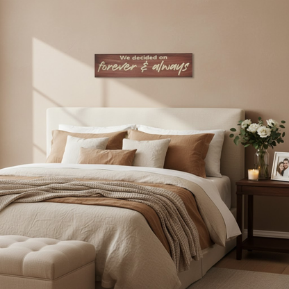 Romantic “Forever & Always” carved wood sign displayed above bed in cozy bedroom