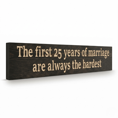 Angled side view of funny 25th anniversary CNC-carved wood sign in dark walnut stain showing carved letter depth and solid wood thickness