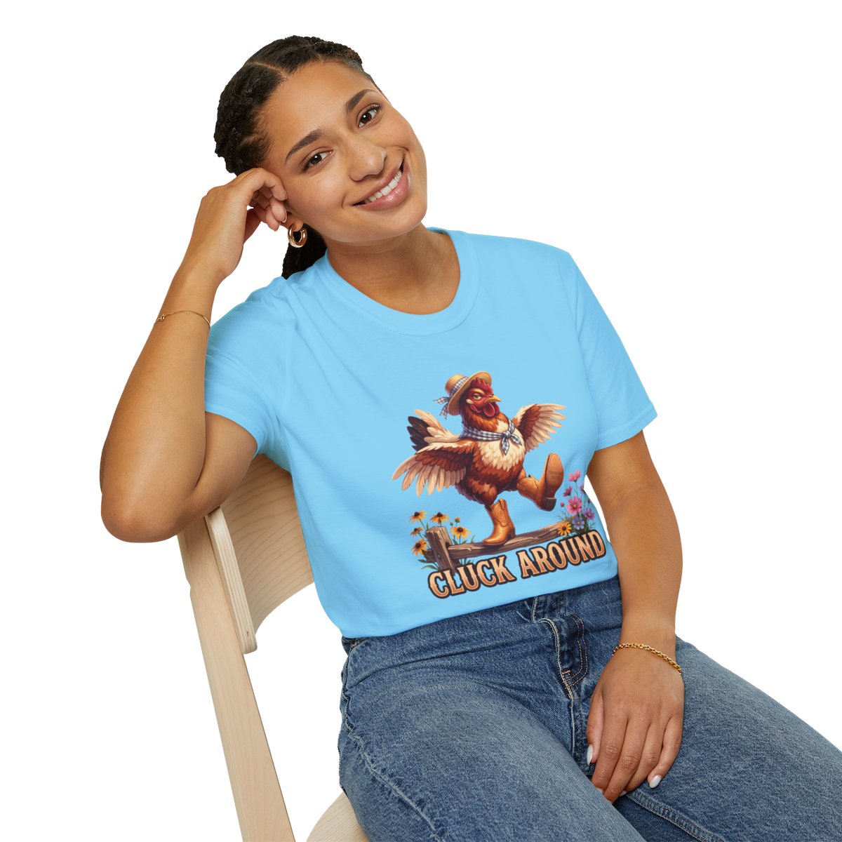 Woman in a light blue Chicken Shirt - Cluck Around tee, seated and smiling, displaying the full chicken graphic