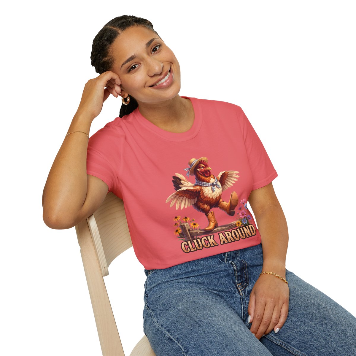 Woman in a coral Chicken Shirt - Cluck Around tee, seated and smiling, displaying the full chicken graphic