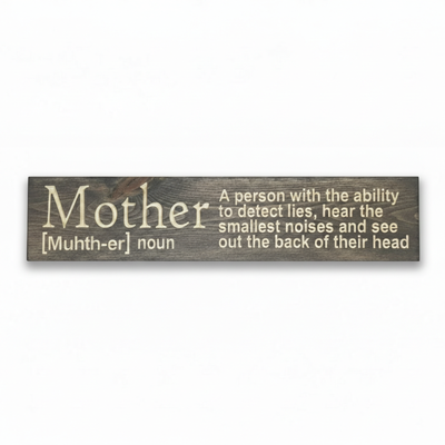 sdfFront-facing view of a "Mother" dictionary definition wood sign in a dark walnut finish, featuring the humorous quote: "A person with the ability to detect lies, hear the smallest noises, and see out the back of their head