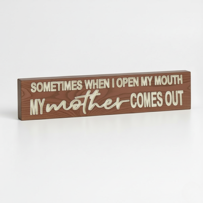 Angled view of a solid wood funny mother quote sign with deep CNC-carved lettering.