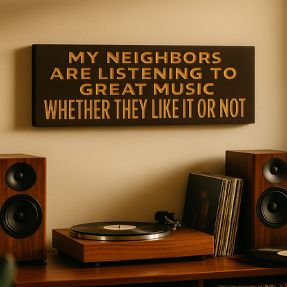 Funny music wall sign “My Neighbors Are Listening to Great Music” hanging above a record player and speakers in a music room.