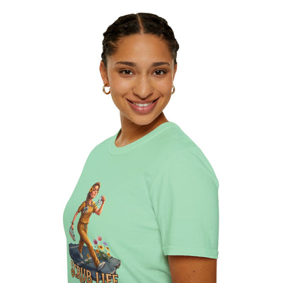 A close-up side profile of a smiling woman wearing a light mint green "Nurse Shirt - Scrub Life" tee, highlighting the graphic