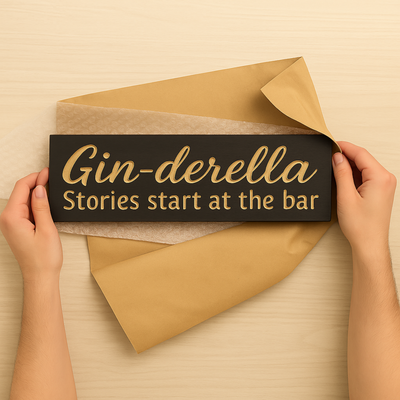 Unboxing the Gin-derella carved wood bar sign with kraft wrap and bubble liner.