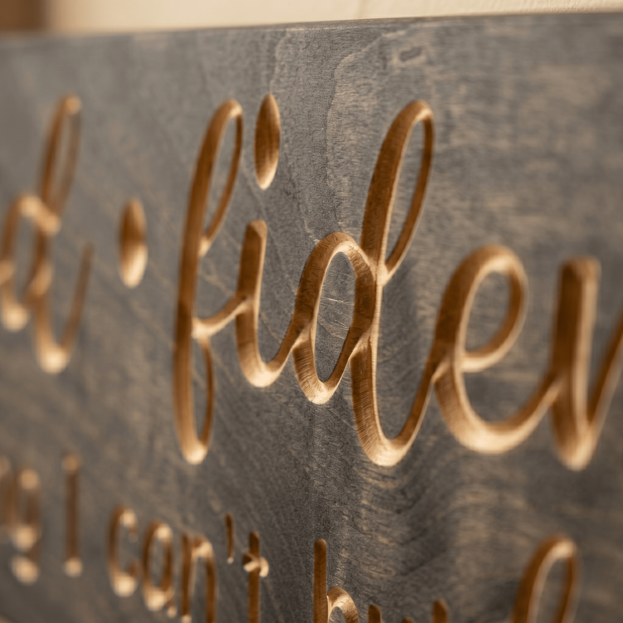 Close-up macro detail of CNC-carved Godfidence lettering showing natural wood grain beneath gray stain finish, handcrafted by Bluegrass Gifts