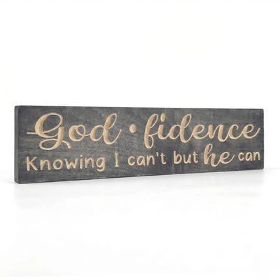 Angled view of the Godfidence wooden faith sign showcasing the dimensional depth of CNC-carved lettering against a gray-stained solid wood background