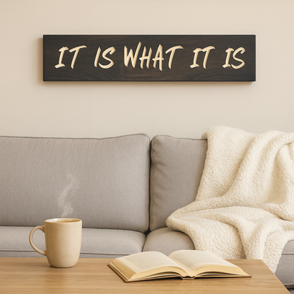 Rustic “It Is What It Is” wooden sign styled above a couch in a farmhouse living room.
