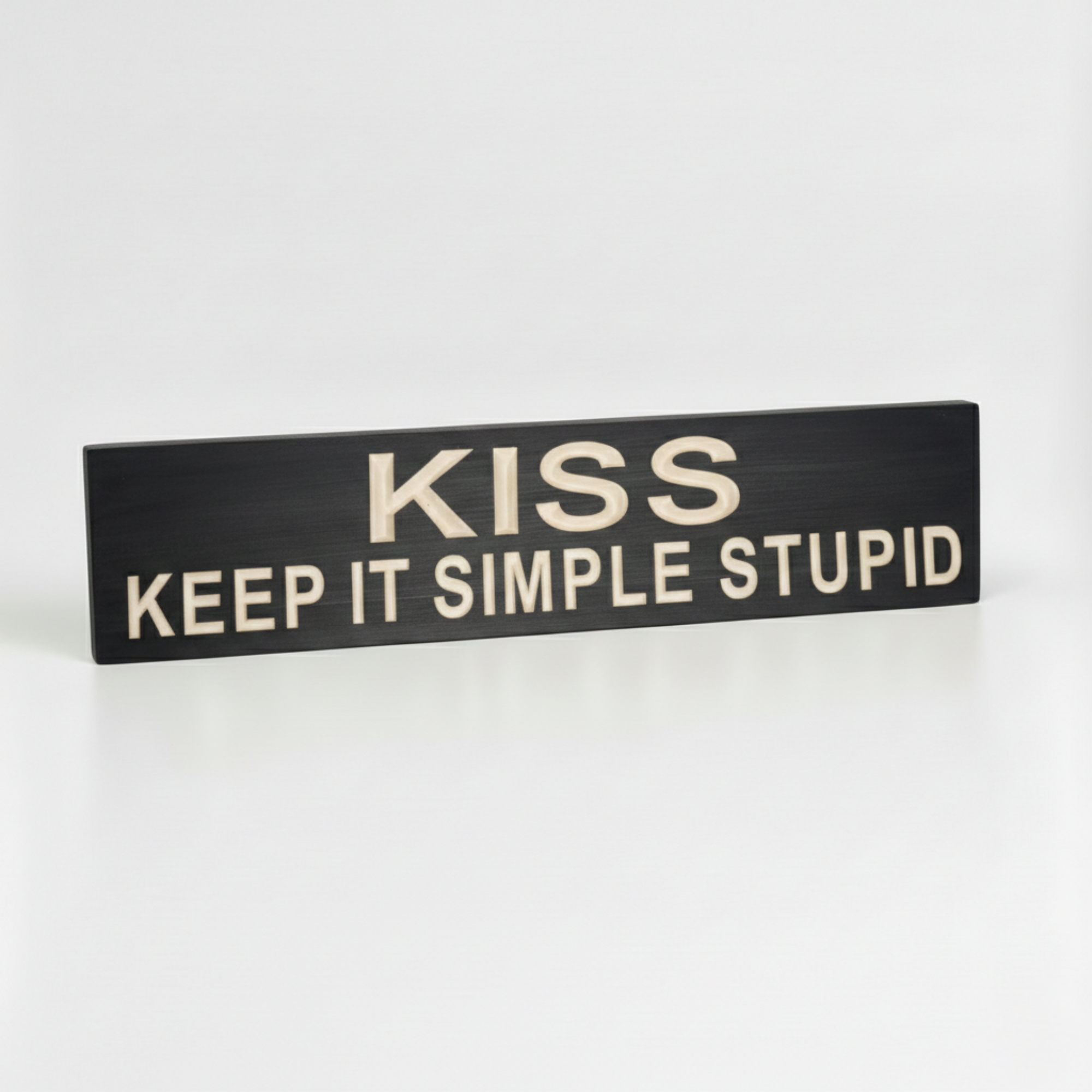 Side-angled view of a solid wood KISS Keep It Simple Stupid plaque, showing the substantial thickness and premium CNC-carved depth of the lettering.