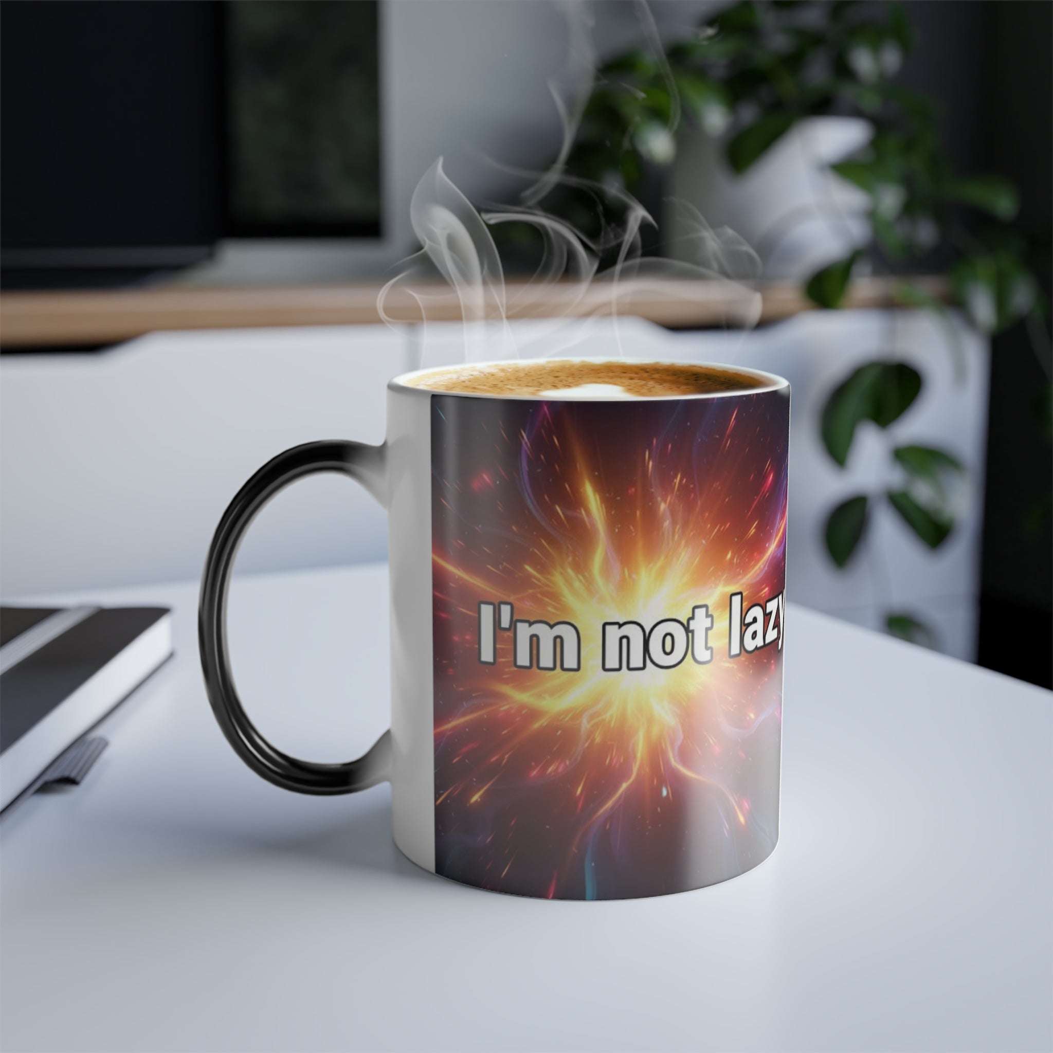 I’m Not Lazy cosmic mug on modern desk with hot coffee, showing bright starburst design and witty quote.