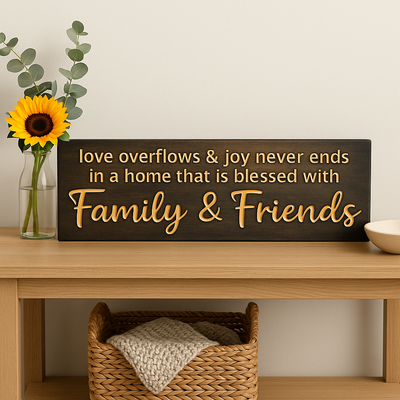 “Love Overflows and Joy Never Ends” Family & Friends wooden wall sign styled on console table with sunflower vase.