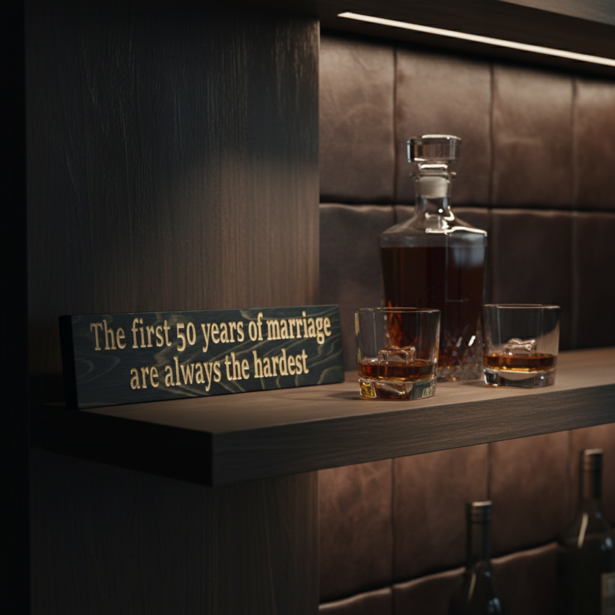 "Rustic carved wood marriage sign styled on a modern bar shelf next to a bourbon decanter, perfect for a man cave or den."