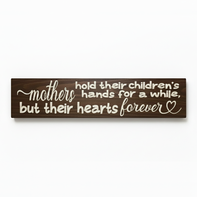 Deeply carved solid wood sign featuring the quote "Mothers hold their children's hands for a while but their hearts forever" in walnut finish by Bluegrass Gifts.