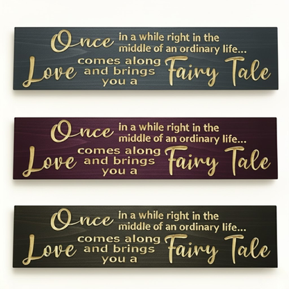 Three color variations of “Once in a while love brings you a fairy tale” carved wooden signs — multiple finishes including black, burgundy, and gray tones.