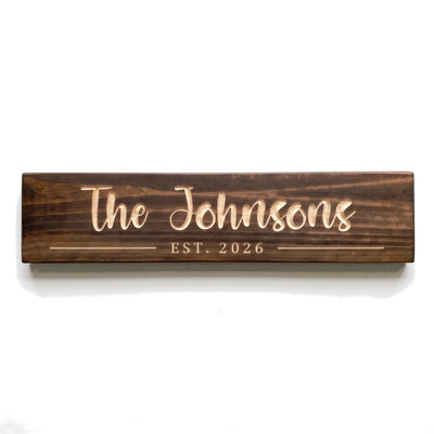 Personalized The Johnsons sign carved into solid wood in a Dark Walnut finish, straight on, on a white background (studio photo)