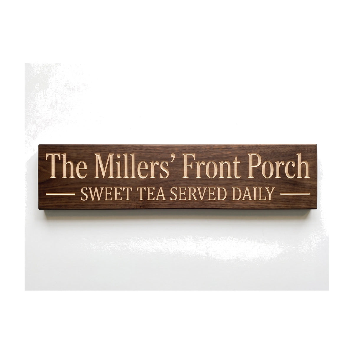 Personalized The Millers' Front Porch sign carved into solid wood in a Dark Walnut finish, straight on, on a white background (studio photo)