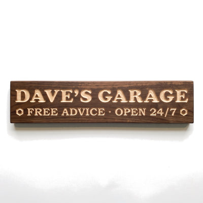 Personalized Dave's Garage sign carved into solid wood in a Dark Walnut finish, straight on, on a white background (studio photo)