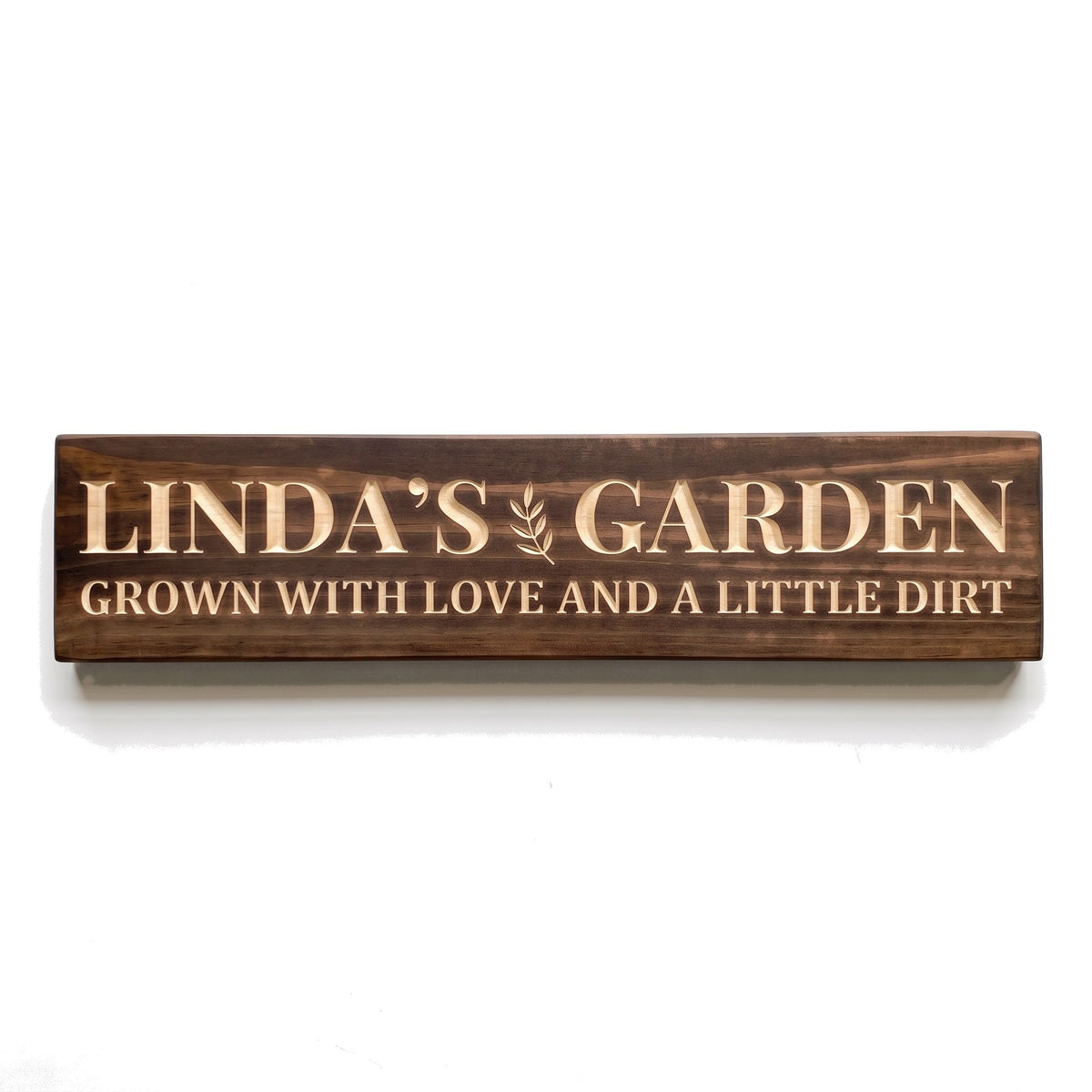 Personalized Linda's Garden sign carved into solid wood in a Dark Walnut finish, straight on, on a white background (studio photo)