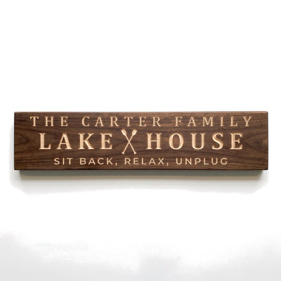 Personalized The Carter Family Lake House sign carved into solid wood in a Dark Walnut finish, straight on, on a white background (studio photo)