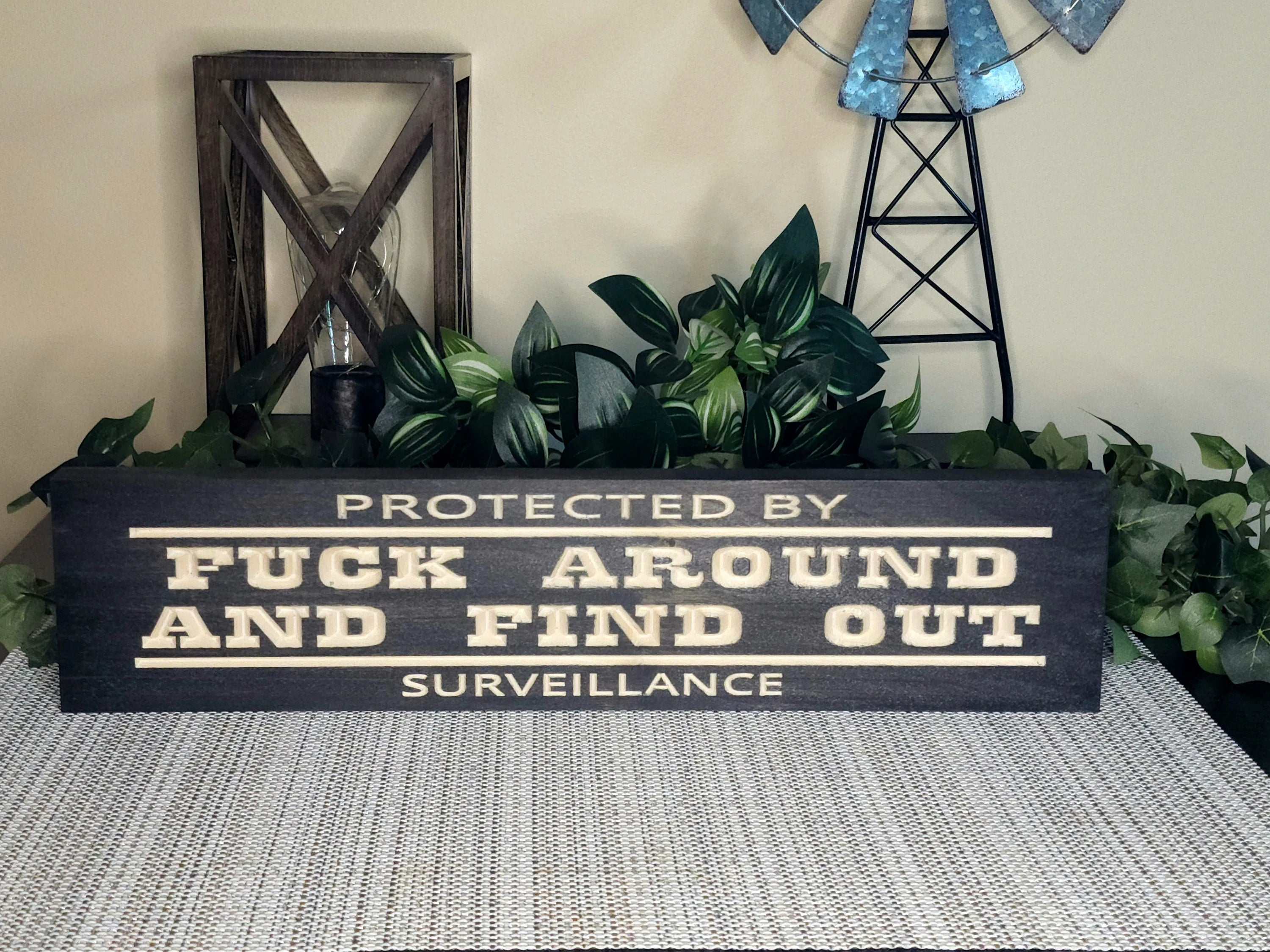 protected by surveillance sign, sarcastic home sign, outdoor warning sign, wood property sign
