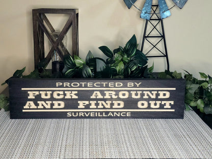 protected by surveillance sign, sarcastic home sign, outdoor warning sign, wood property sign

