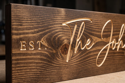 Personalized family name sign carved lettering close-up
