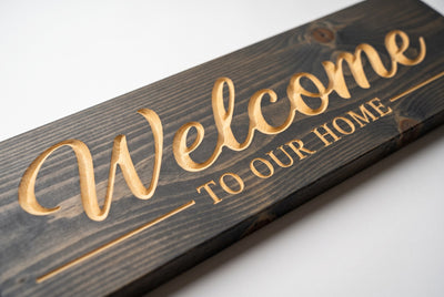 Welcome to Our Home carved lettering close-up